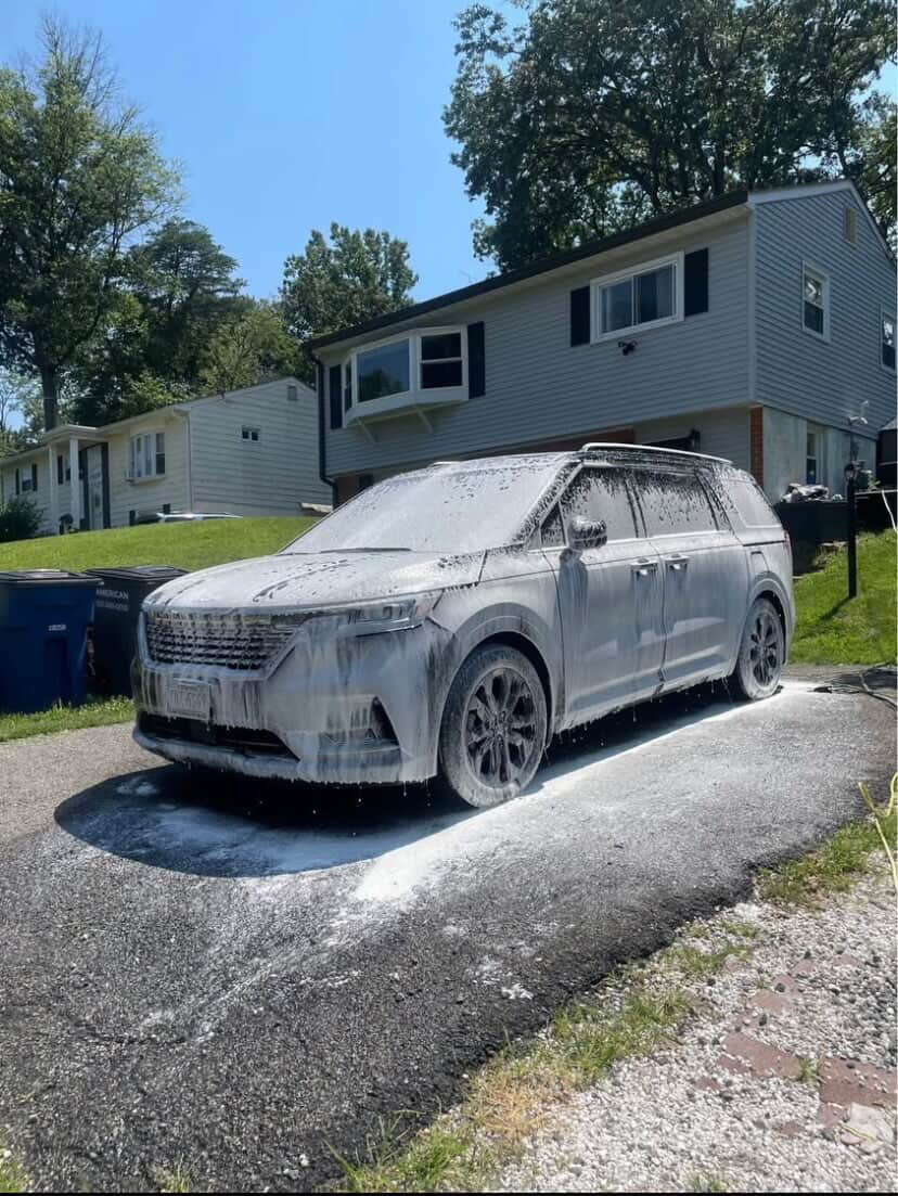 SUV covered in foam during an exterior detail wash